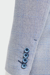 Close-up of a light blue checkered suit with three buttons on a white background
