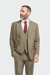 Man wearing a brown suit with a red tie on a white background