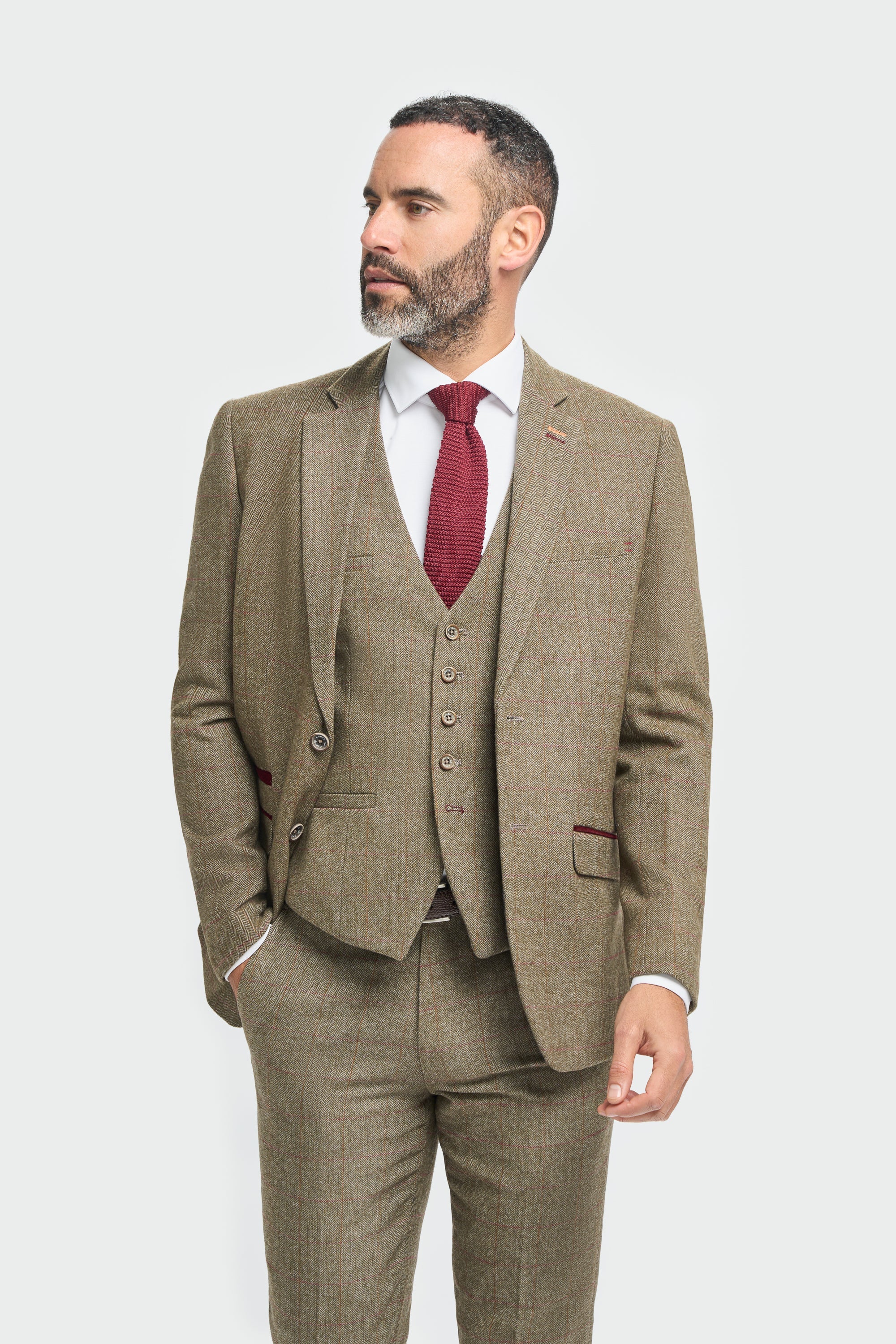Man wearing a brown suit with a red tie on a white background